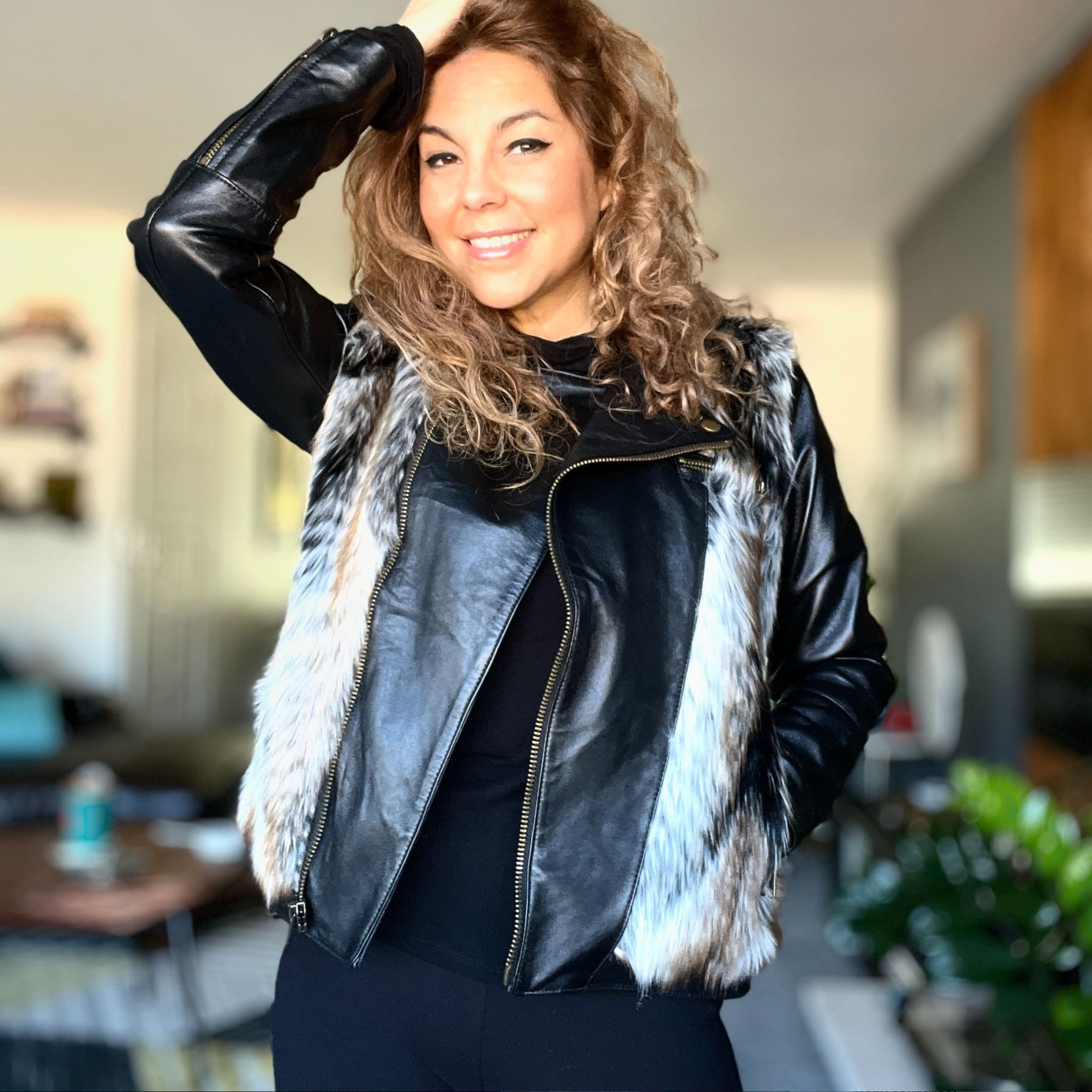 Priscilla Ortiz posing with her hand in her hair.